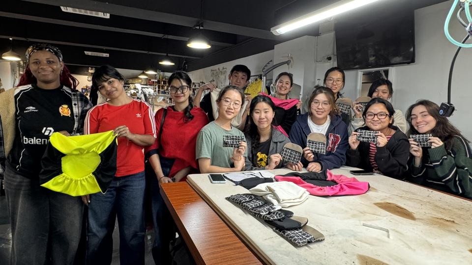 Students holding their products to take a group photo 