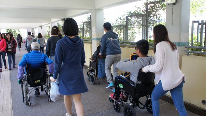 Volunteers experiencing the accessibility facilities with disabled people