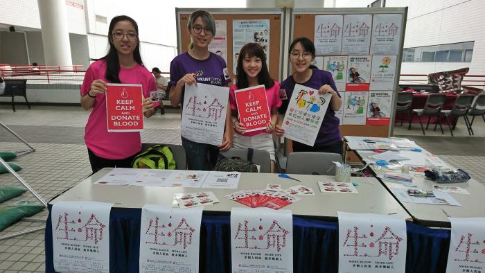 Volunteers promoting the event at the information booth