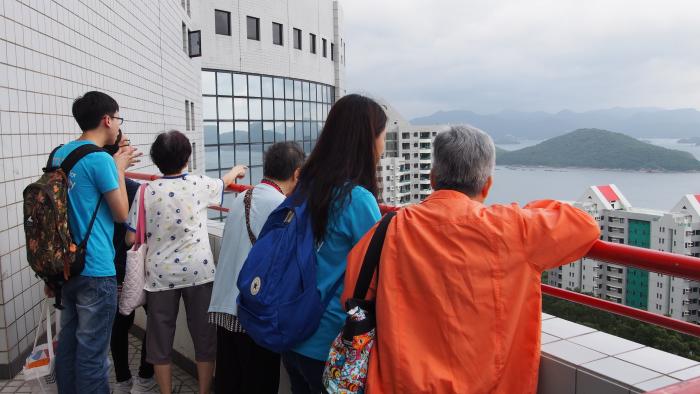 Volunteers and the elderly admiring the view of HKUST Campus