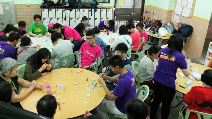 Volunteers doing artwork together with the recipients