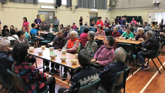 Elderly gathering in the hall to have soup and chat together