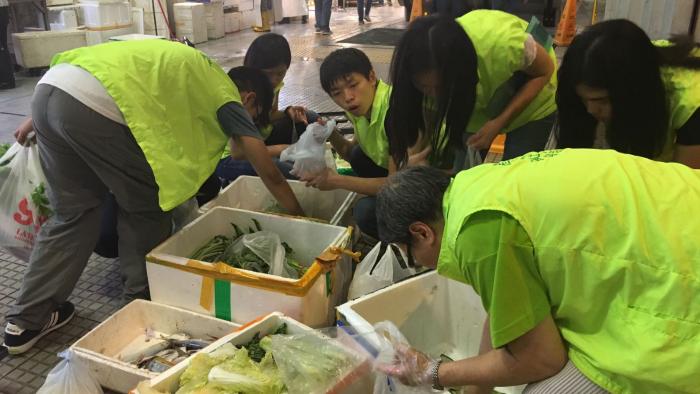 Student volunteer collecting the vegetables