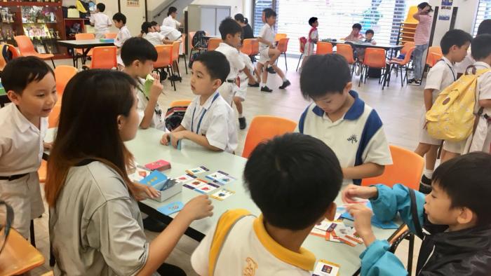 Student volunteer leading a booth game