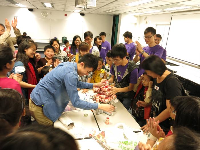 Kids and parents playing a group game together happily