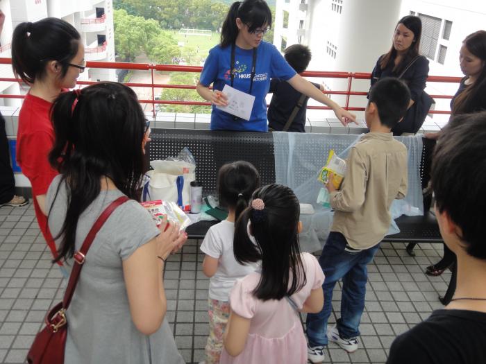 Volunteer distributing different game materials to the children