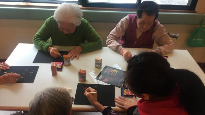 Volunteers doing art crafts with elderly