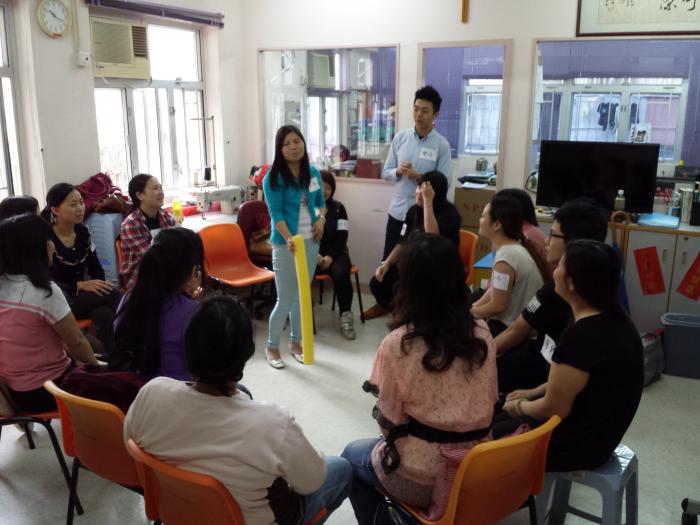 Volunteers and women playing the warm-up activity
