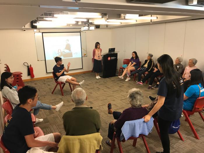 Elderly learning exercise with volunteers