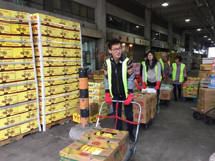 Volunteers saving boxes of bananas from going to the landfill