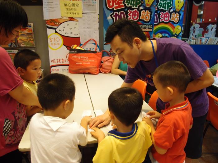 Volunteer teaching a new game to the children