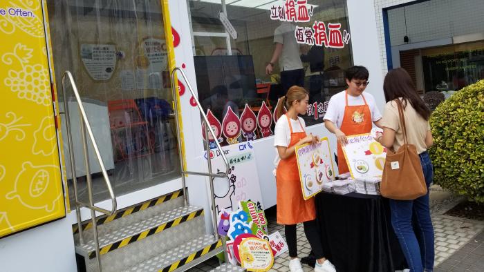 Volunteers hosting booth games to promote blood donation