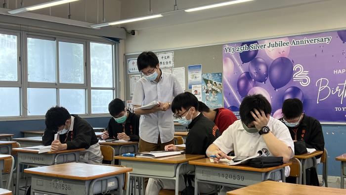 Volunteers helping students to solve a problem