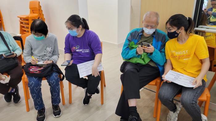 Volunteers teaching seniors how to use smartphones