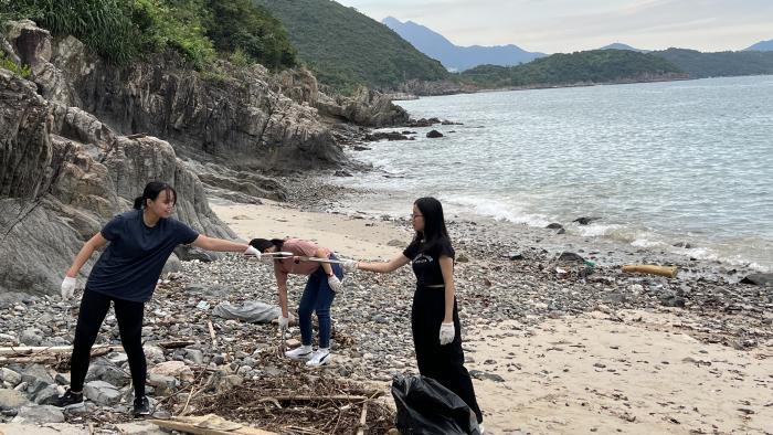 Volunteers working together to pick up trash.