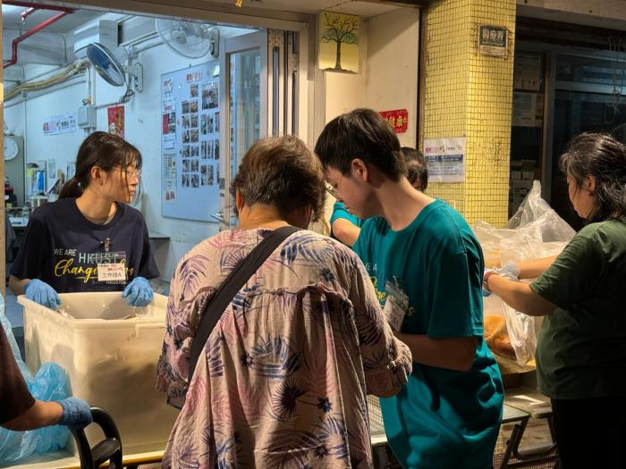 Volunteers redistributing food to people in need