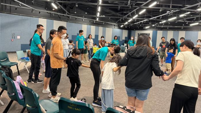 All volunteers and families play checkpoint game together
