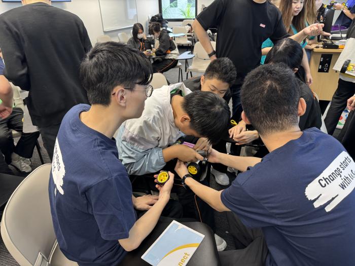 Volunteers building cars with the students.