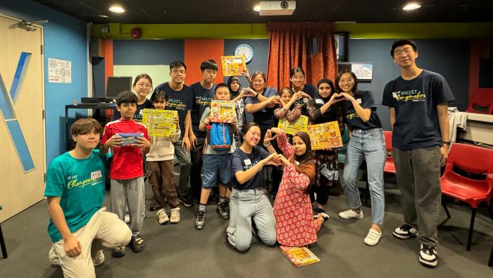 A group picture of the volunteers and the children.