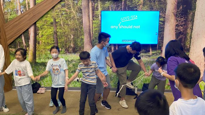 Volunteers playing checkpoint game with children