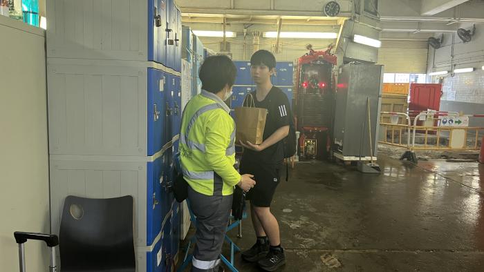 Student listening to the street cleaners' life stories
