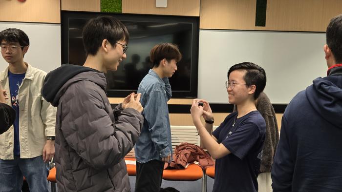 Students signing "Nice to meet you" with a new friend