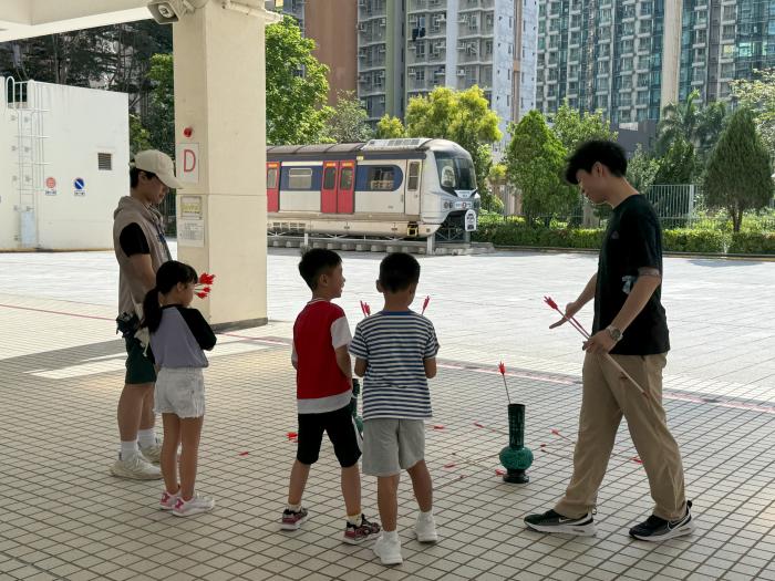 Volunteers guiding children in learning about Pitch-Pot