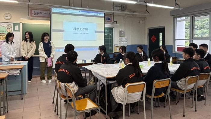 Volunteers providing science workshop to secondary students