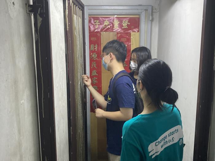 Volunteers visiting people in subdivided flats