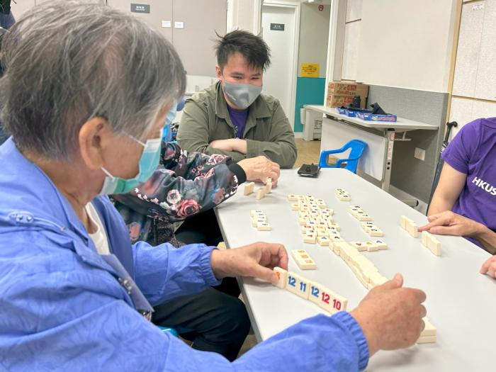 Volunteers teaching Elderly to play rummikub