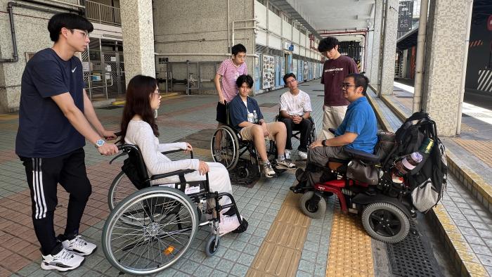 Students exploring the community in wheelchairs