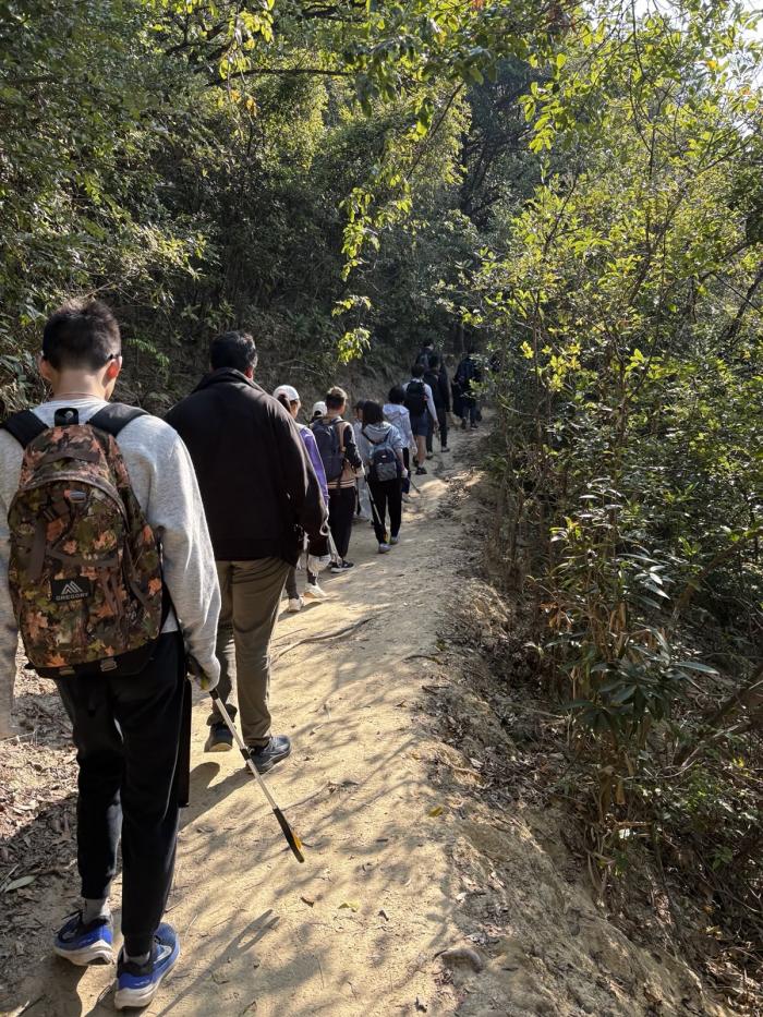 Volunteers scanning the trails for litter