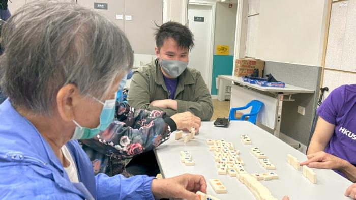 Volunteers teaching Elderly to play rummikub